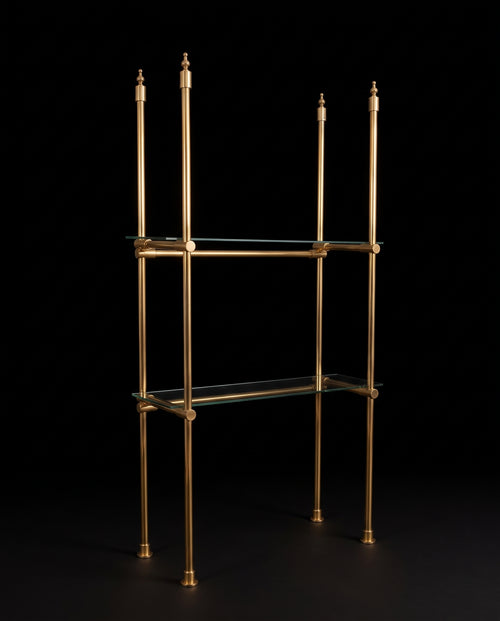 Freestanding four-post brass étagère with turned finials and two clear glass shelves