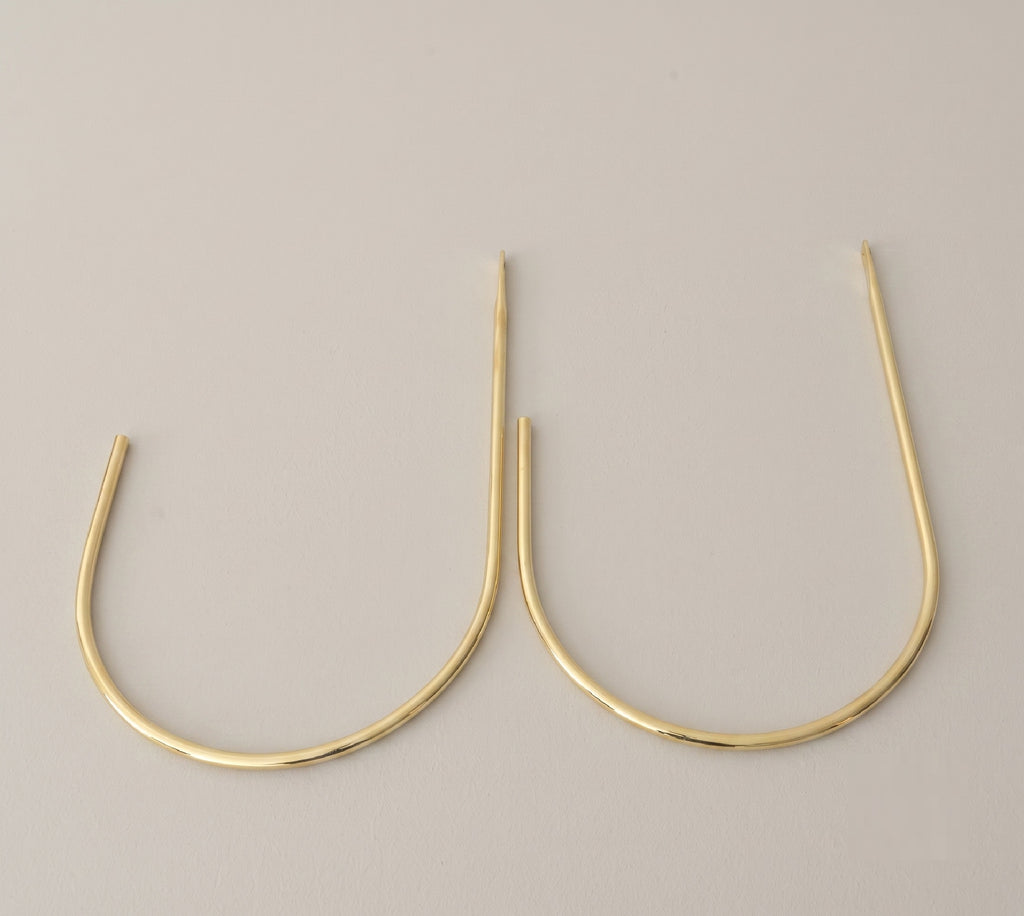 Close view of the wall mount on a crescent brass curtain tieback