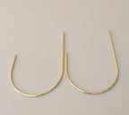 Close view of the wall mount on a crescent brass curtain tieback