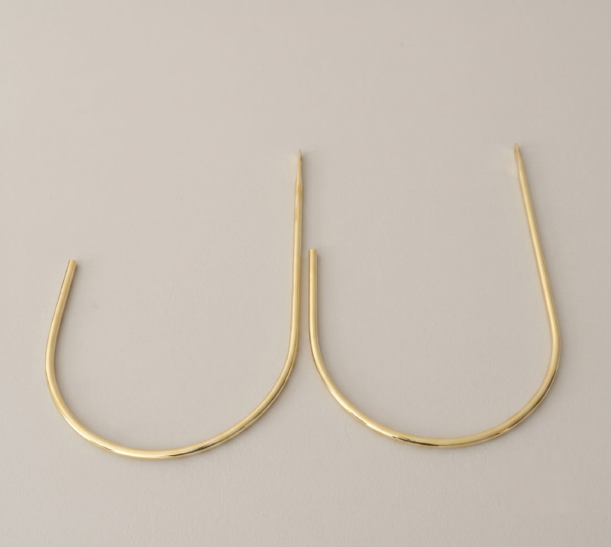 Close view of the wall mount on a crescent brass curtain tieback