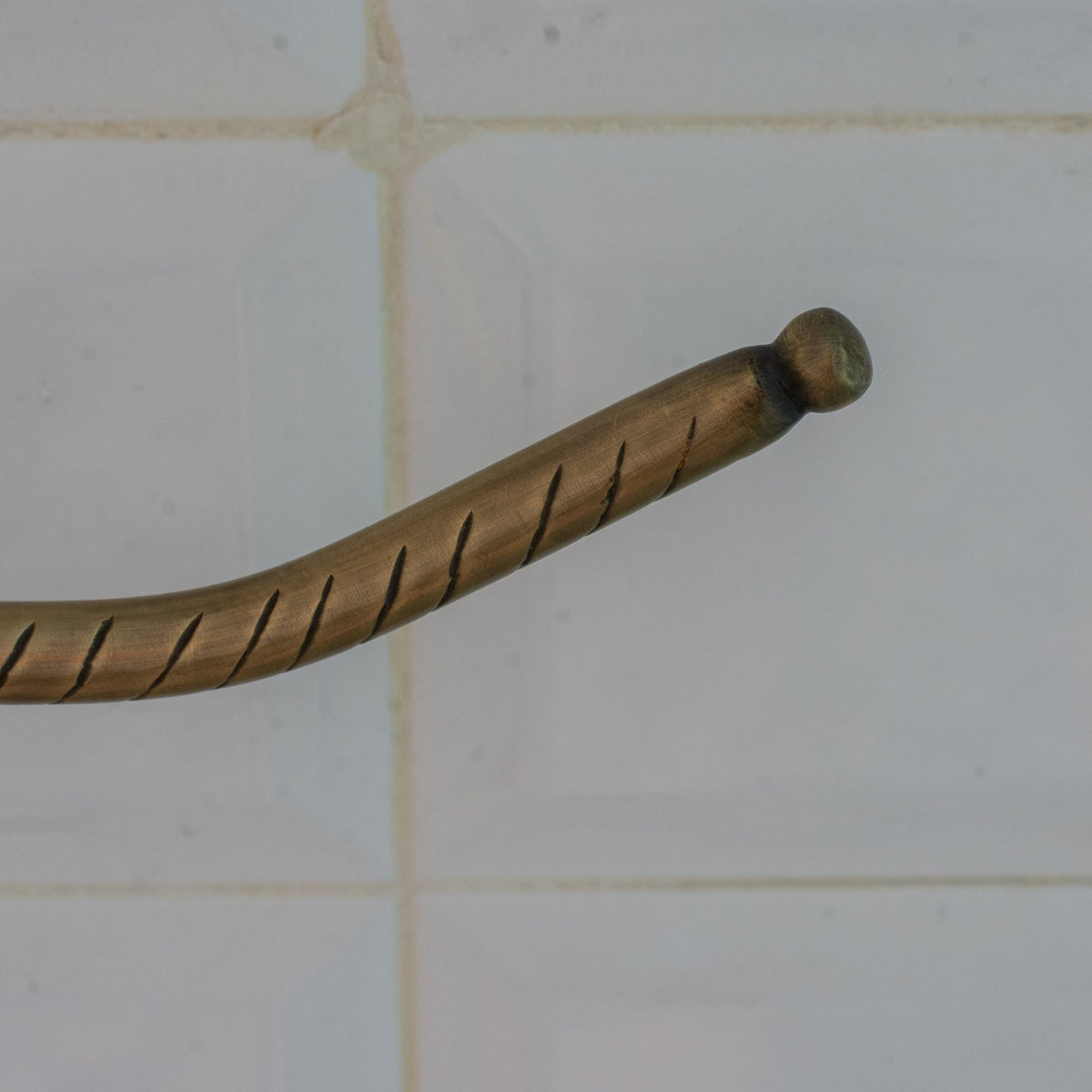 Detail of the engraved pattern on a brass toilet paper holder